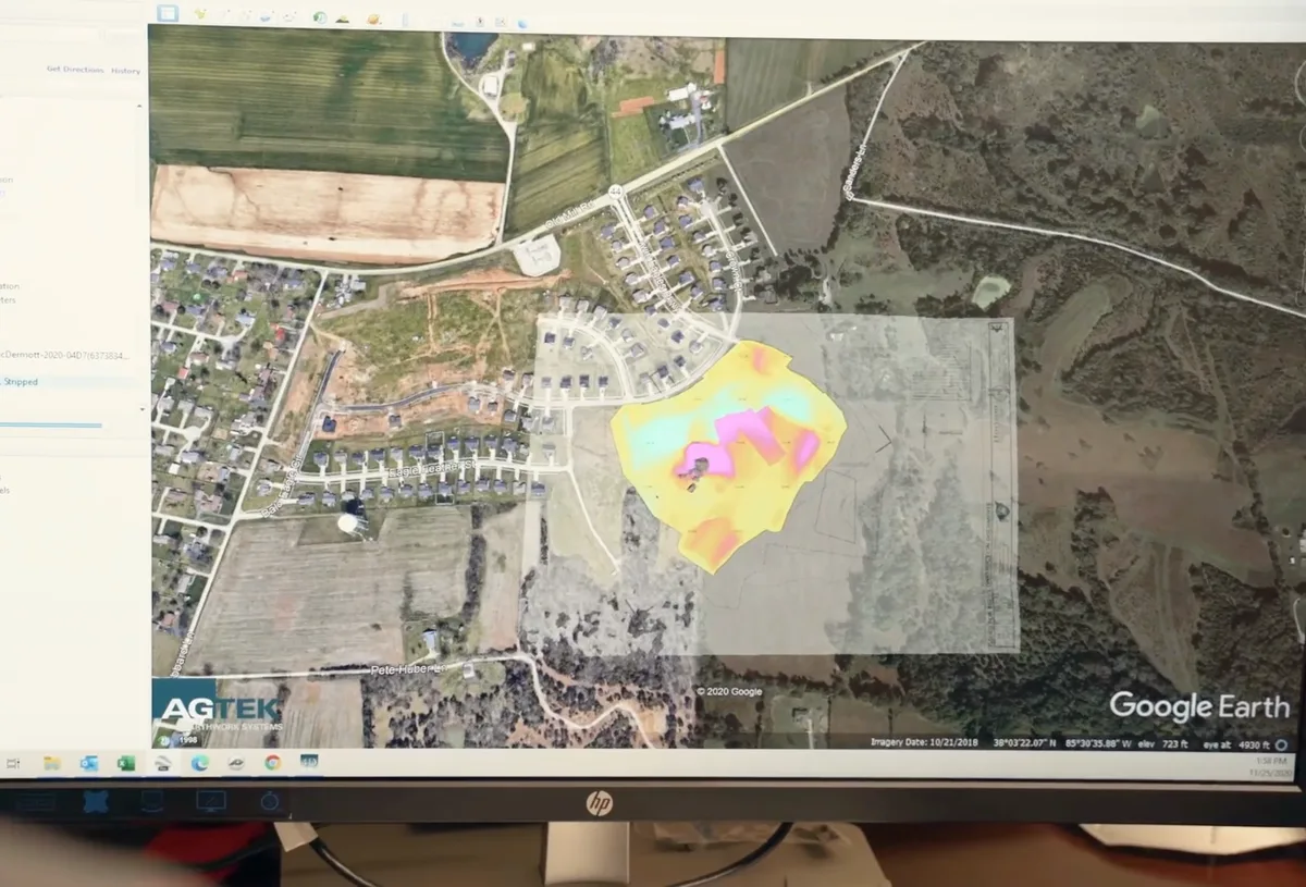 Earth Works site-planning software on a computer monitor showing a cut and fill map of a Kentucky job site